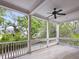 Spacious porch with white railing and ceiling fan provides a relaxing outdoor space with lovely neighborhood views at 2206 Weepoolow Trl, Charleston, SC 29407