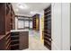 Large walk-in closet featuring custom shelving and storage solutions for organization with carpet flooring at 2206 Weepoolow Trl, Charleston, SC 29407
