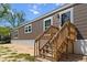 Home exterior showcasing a wooden staircase leading to the front door and complementary brown siding at 226 Collier Ln, Moncks Corner, SC 29461