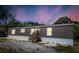 Exterior of home, including front porch and new looking siding and storm windows at 226 Collier Ln, Moncks Corner, SC 29461