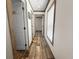 Hallway with hardwood-look flooring, white walls and trim connecting different parts of the home at 226 Collier Ln, Moncks Corner, SC 29461