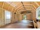 Unfinished interior space with wood framing and a large window, offering customization potential at 226 Collier Ln, Moncks Corner, SC 29461