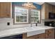 Kitchen includes a deep double-basin sink, marble countertops and wood cabinets at 226 Collier Ln, Moncks Corner, SC 29461