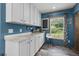 Kitchen area features white cabinets, marble countertops and a window view at 226 Collier Ln, Moncks Corner, SC 29461