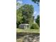 This outbuilding or ' shed' with a porch is surrounded by mature trees offering a quiet retreat at 226 Collier Ln, Moncks Corner, SC 29461