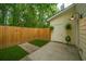 Private backyard featuring a wood fence, grass, and a back entrance at 241 Howle Ave # H, Charleston, SC 29412