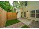 Enclosed backyard featuring a wood fence, concrete patio, and manicured garden at 241 Howle Ave # H, Charleston, SC 29412