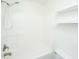 Clean bathroom features a white tub-shower combination, toilet and shelving at 241 Howle Ave # H, Charleston, SC 29412