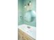 Modern bathroom with updated lighting, mirror, and fixtures on light green walls at 241 Howle Ave # H, Charleston, SC 29412