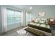 Bright bedroom with large windows, a comfortable bed, and stylish decor accents at 241 Howle Ave # H, Charleston, SC 29412
