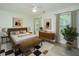 Cozy bedroom featuring a ceiling fan, stylish decor, and natural light from two windows at 241 Howle Ave # H, Charleston, SC 29412