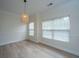 Bright dining room with natural light, modern light fixture and wood-look flooring at 241 Howle Ave # H, Charleston, SC 29412