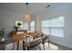 Inviting dining room featuring modern furniture, a decorative light fixture, and a neutral color palette at 241 Howle Ave # H, Charleston, SC 29412