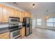 Open concept kitchen featuring stainless steel appliances, a pendant light, and dining area at 241 Howle Ave # H, Charleston, SC 29412