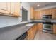 Well-lit kitchen featuring stainless steel appliances, light wood cabinets, and gray countertops at 241 Howle Ave # H, Charleston, SC 29412