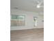 Inviting living room with wood-look flooring and lots of natural light from the window and glass door at 241 Howle Ave # H, Charleston, SC 29412