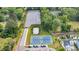 Aerial view showcases tennis courts, a large parking lot, and tree-lined surroundings for recreational amenities at 2729 Battery Pringle Dr, Johns Island, SC 29455