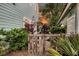 Charming backyard with a rustic wooden gate leading to lush greenery and a glimpse of the home's architecture at 2729 Battery Pringle Dr, Johns Island, SC 29455