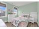 Cozy bedroom with mint walls, a white bed frame, hardwood flooring, and natural light at 2729 Battery Pringle Dr, Johns Island, SC 29455