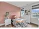 Bright bedroom with large windows, a modern bedframe, hardwood flooring, and a peach accent wall at 2729 Battery Pringle Dr, Johns Island, SC 29455