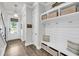 Welcoming entryway with wood floors, a built-in bench and shelving, and a view of the front door at 2729 Battery Pringle Dr, Johns Island, SC 29455