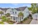 Charming two-story home featuring a welcoming front porch, well-manicured lawn, and palm trees at 2729 Battery Pringle Dr, Johns Island, SC 29455