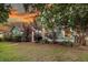 Landscaped exterior showcasing manicured lawn, mature trees, and vibrant shrubs against a picturesque sunset backdrop at 2729 Battery Pringle Dr, Johns Island, SC 29455