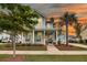Inviting two-story home with a charming porch, well-manicured lawn, and beautiful landscaping at 2729 Battery Pringle Dr, Johns Island, SC 29455