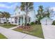 Inviting two-story home with a charming front porch, well-maintained lawn, and a detached garage at 2729 Battery Pringle Dr, Johns Island, SC 29455