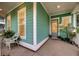 Inviting turquoise home exterior featuring a cozy seating area with plants on a covered front porch at 2729 Battery Pringle Dr, Johns Island, SC 29455
