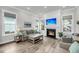 Cozy living room with a fireplace, large windows, and comfortable seating at 2729 Battery Pringle Dr, Johns Island, SC 29455