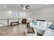 Open living area with hardwood floors, white walls, and lots of natural light from many windows at 2729 Battery Pringle Dr, Johns Island, SC 29455