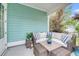 Relaxing outdoor space featuring comfortable wicker seating with plush cushions and a tranquil, plant-filled setting at 2729 Battery Pringle Dr, Johns Island, SC 29455