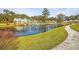 Pond with fountain, surrounded by green grass and walking path, enhancing the community's appeal at 2729 Battery Pringle Dr, Johns Island, SC 29455