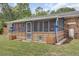 Screened-in back porch with blue accents, seamlessly blending indoor comfort with outdoor views and fresh air at 296 Oxford Rd, Ladson, SC 29456