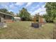 Large grassy backyard featuring a shed, porch, and unique wood structure, offering ample space for outdoor enjoyment at 296 Oxford Rd, Ladson, SC 29456