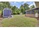 Expansive backyard featuring a shed and screened-in porch, perfect for outdoor activities and relaxation at 296 Oxford Rd, Ladson, SC 29456