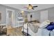 Comfortable bedroom featuring a ceiling fan, desk, and view into a bathroom at 296 Oxford Rd, Ladson, SC 29456