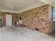 Spacious brick carport with white door, exposed brick wall and concrete flooring at 296 Oxford Rd, Ladson, SC 29456
