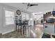 Open concept dining area features a table, ceiling fan, large windows and view to kitchen at 296 Oxford Rd, Ladson, SC 29456