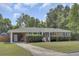 Inviting single-story brick home with lush lawn, carport and a neatly landscaped front yard at 296 Oxford Rd, Ladson, SC 29456