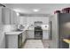 Spacious kitchen with white cabinets, stainless steel appliances, and modern countertops at 296 Oxford Rd, Ladson, SC 29456