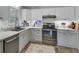 Functional kitchen featuring white cabinets, tile backsplash, stainless steel appliances, and natural light at 296 Oxford Rd, Ladson, SC 29456