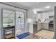 Kitchen with white cabinets, stainless appliances, view to the screened-in porch and hardwood floors at 296 Oxford Rd, Ladson, SC 29456