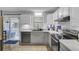 Bright kitchen with white cabinets, stainless steel appliances, and access to a screened-in porch at 296 Oxford Rd, Ladson, SC 29456