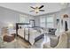 Relaxing main bedroom with a ceiling fan, two windows, side tables, and neutral tones at 296 Oxford Rd, Ladson, SC 29456