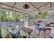 Relaxing sunroom featuring a dog door, ceiling fans, and comfortable seating, perfect for enjoying the outdoors from inside at 296 Oxford Rd, Ladson, SC 29456