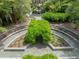 Aerial perspective highlights the property's stunning gardens, with pathways and manicured hedges at 2970 Roseville Rd, Wadmalaw Island, SC 29487