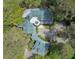 Aerial view highlights the home's distinctive architecture and circular driveway and green roof at 2970 Roseville Rd, Wadmalaw Island, SC 29487