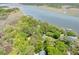 Stunning aerial shot of a waterfront property with mature trees surrounding the homes, private docks and river views at 2970 Roseville Rd, Wadmalaw Island, SC 29487